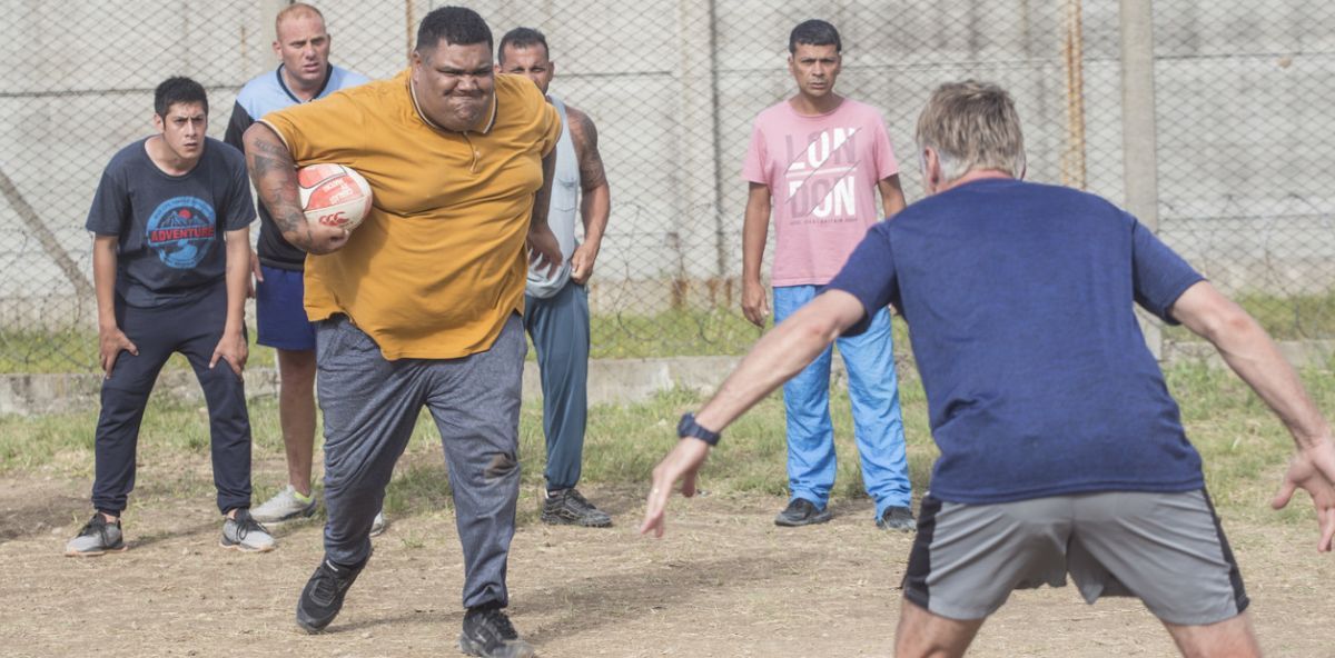 Guillermo Pfening detrás de Coco Oderigo, el entrenador del equipo de rugby carcelario “Espartanos”